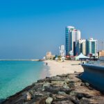 Ajman, United Arab Emirates - December 6, 2018: Ajman Corniche Beach beautiful coast in the city downtown area surrounded by high residential buildings